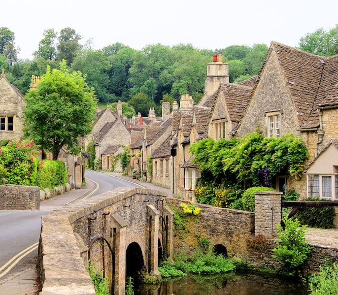 an old stone bridge leading to beautiful stone houses