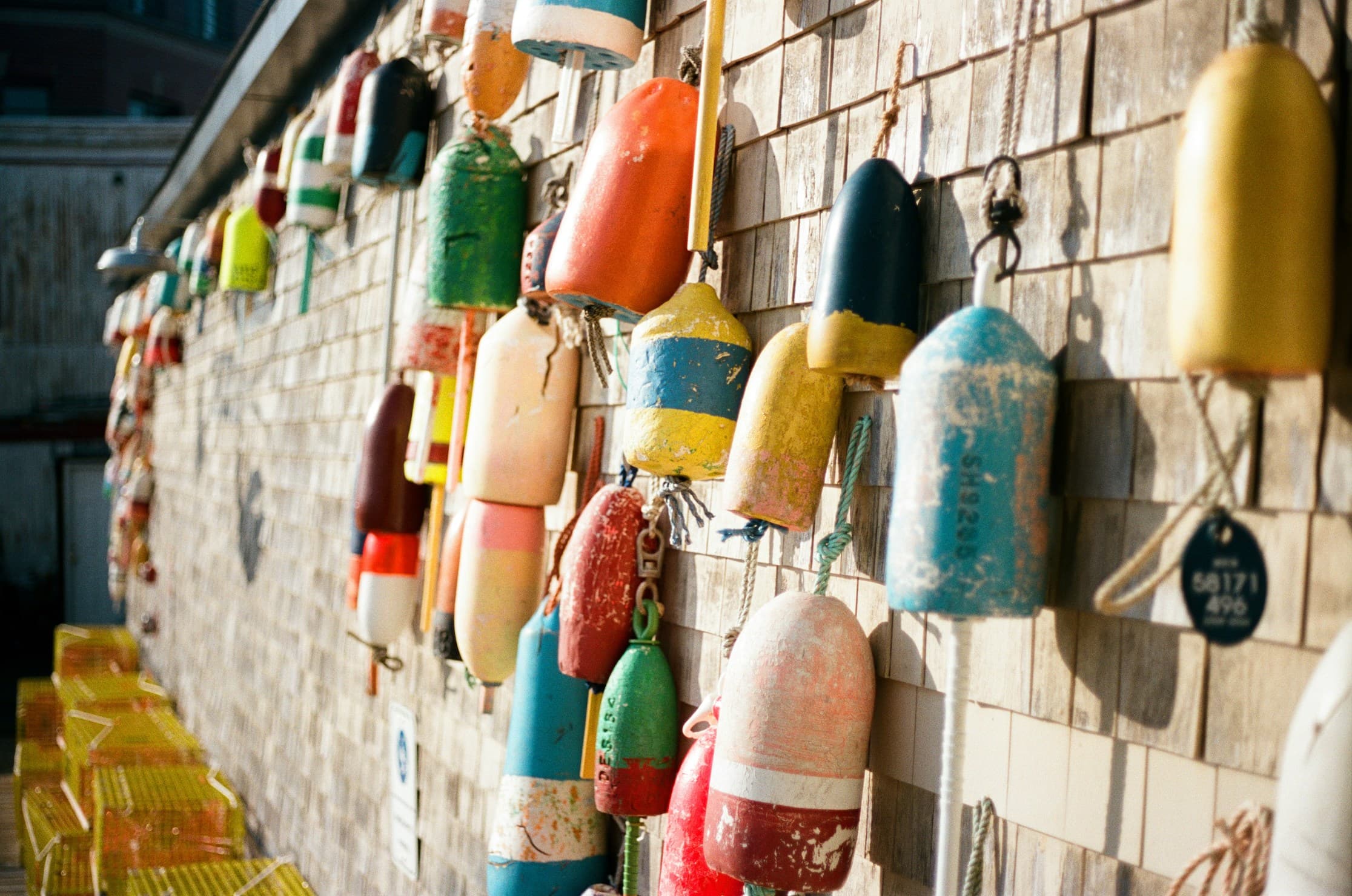 colorful buoys hanging on a dock